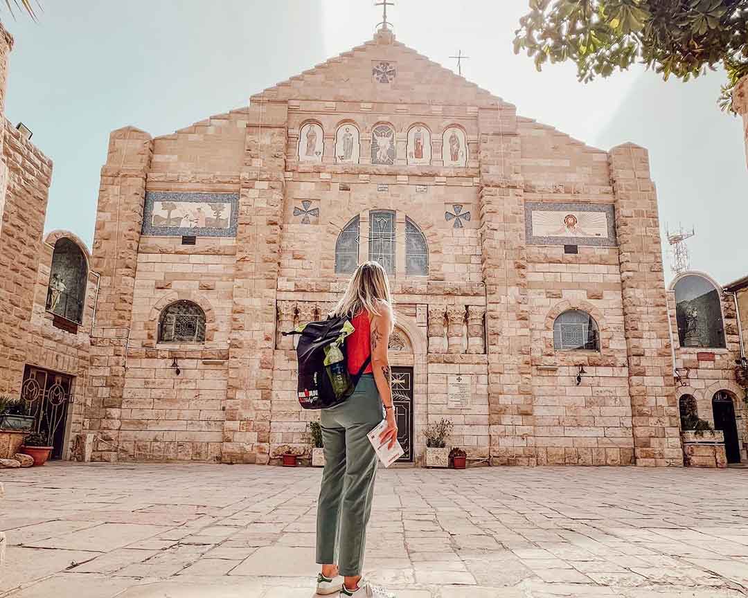 girl stand front of church of wadi mujib