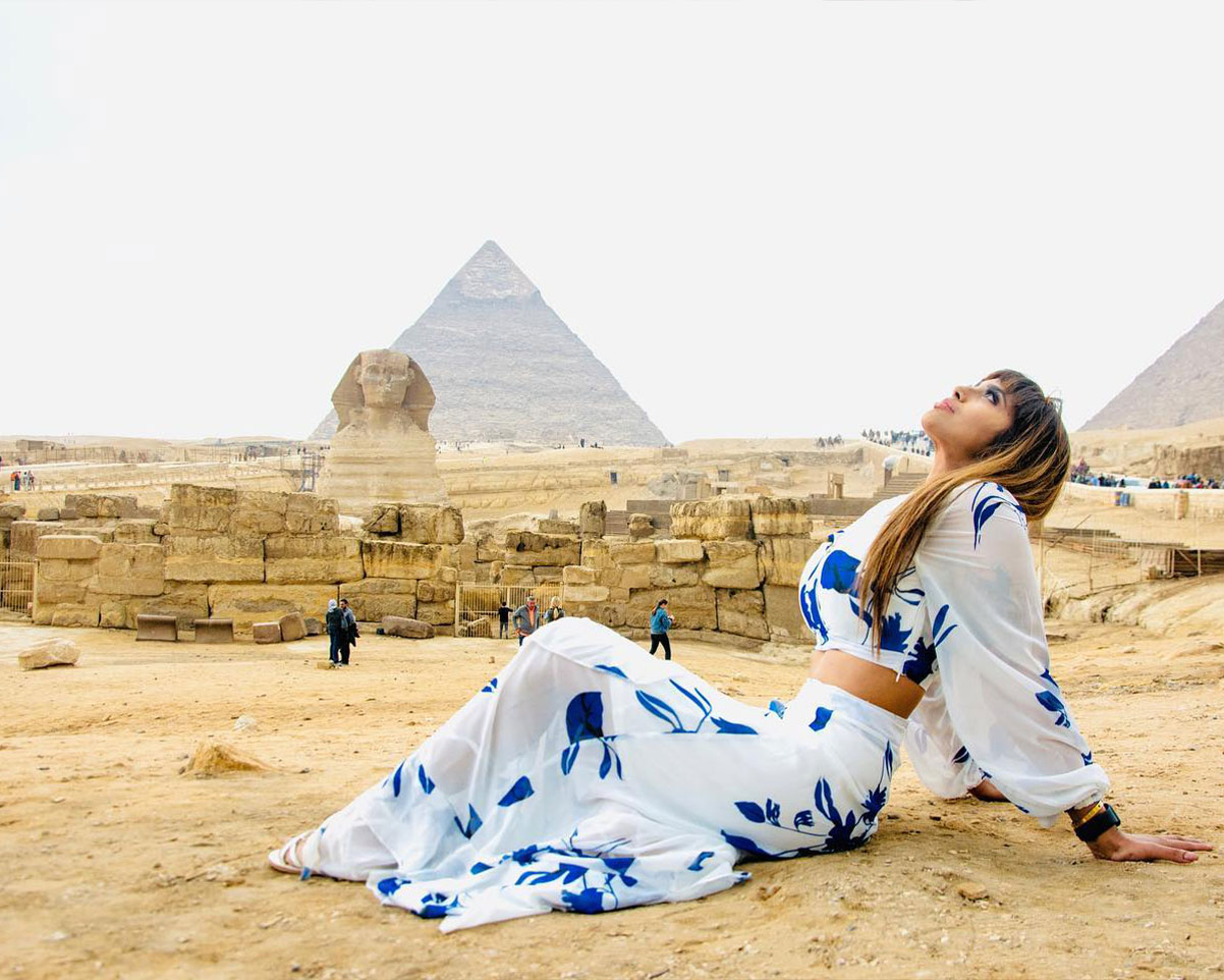 beautiful traveler wearing dress in the pyramids in the tour with iEgypt travels