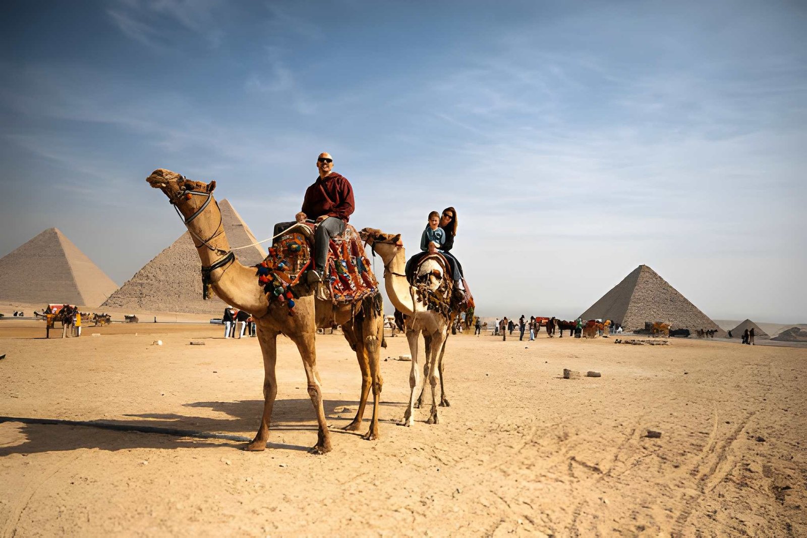 International tourists enjoying a guided tour near the Pyramids of Giza with organized security and a calm travel environment in Egypt
