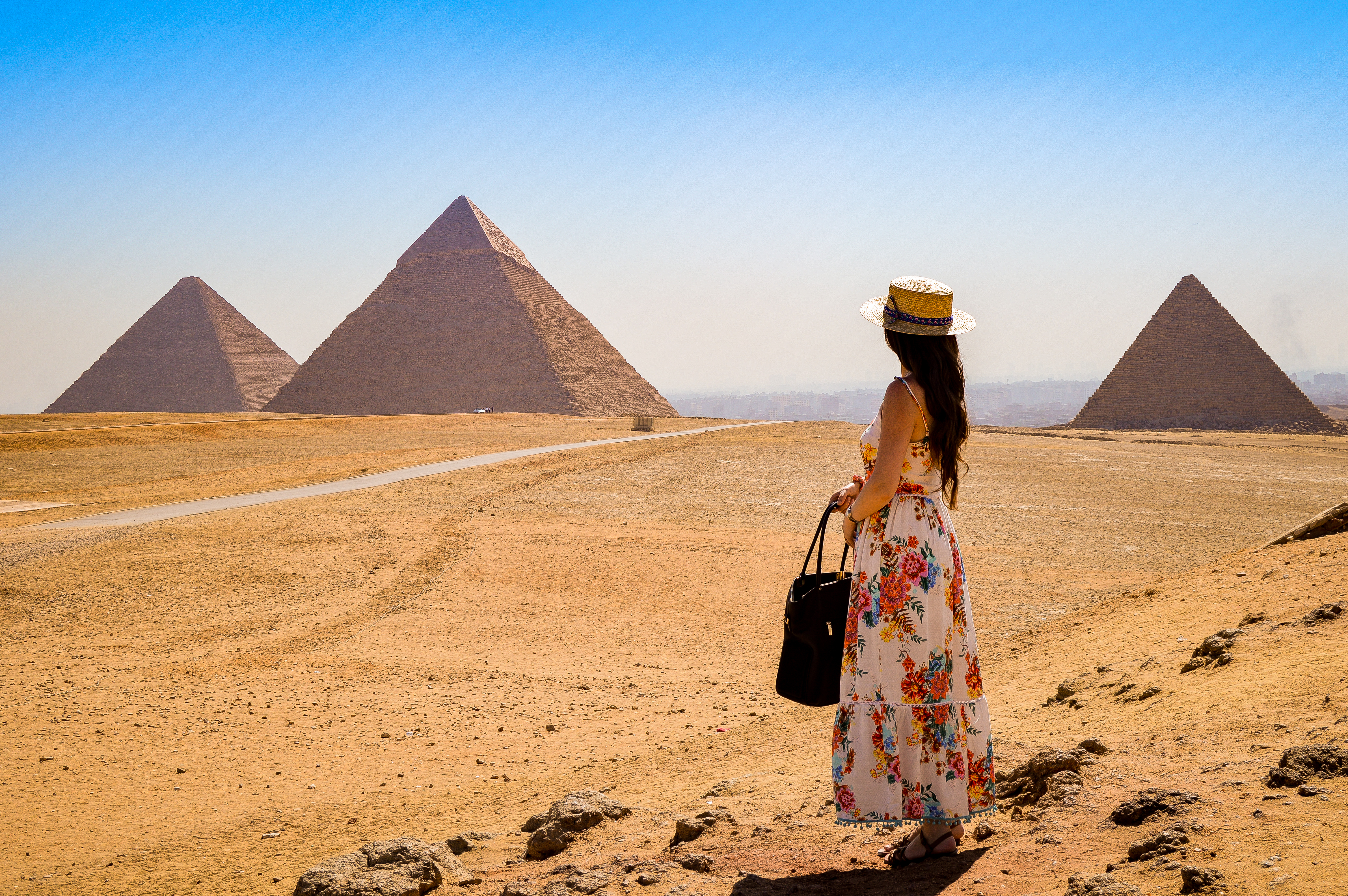 woman standing at giza pyramids egypt desert travel view