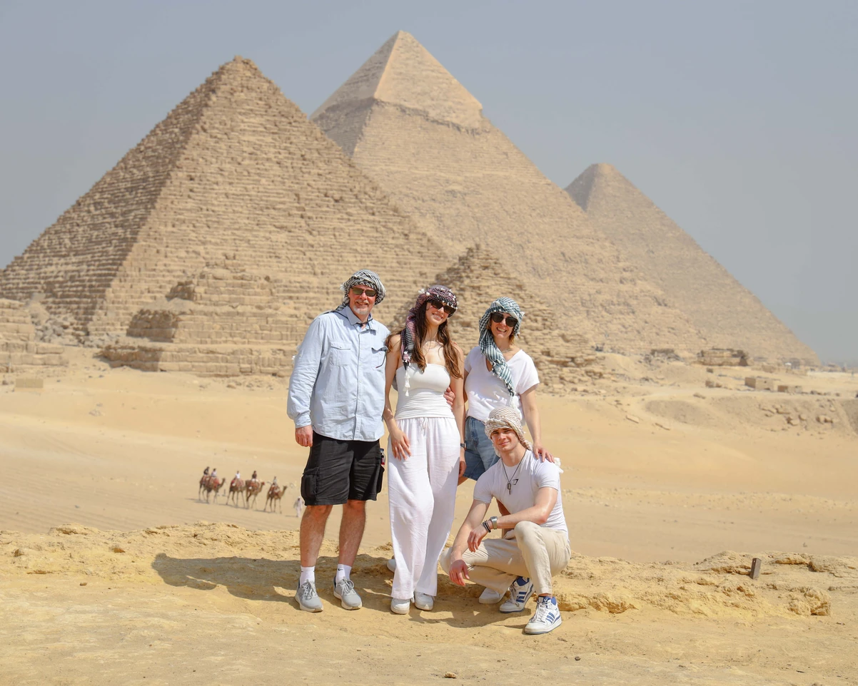 A Family taking photos in front of the pyramids