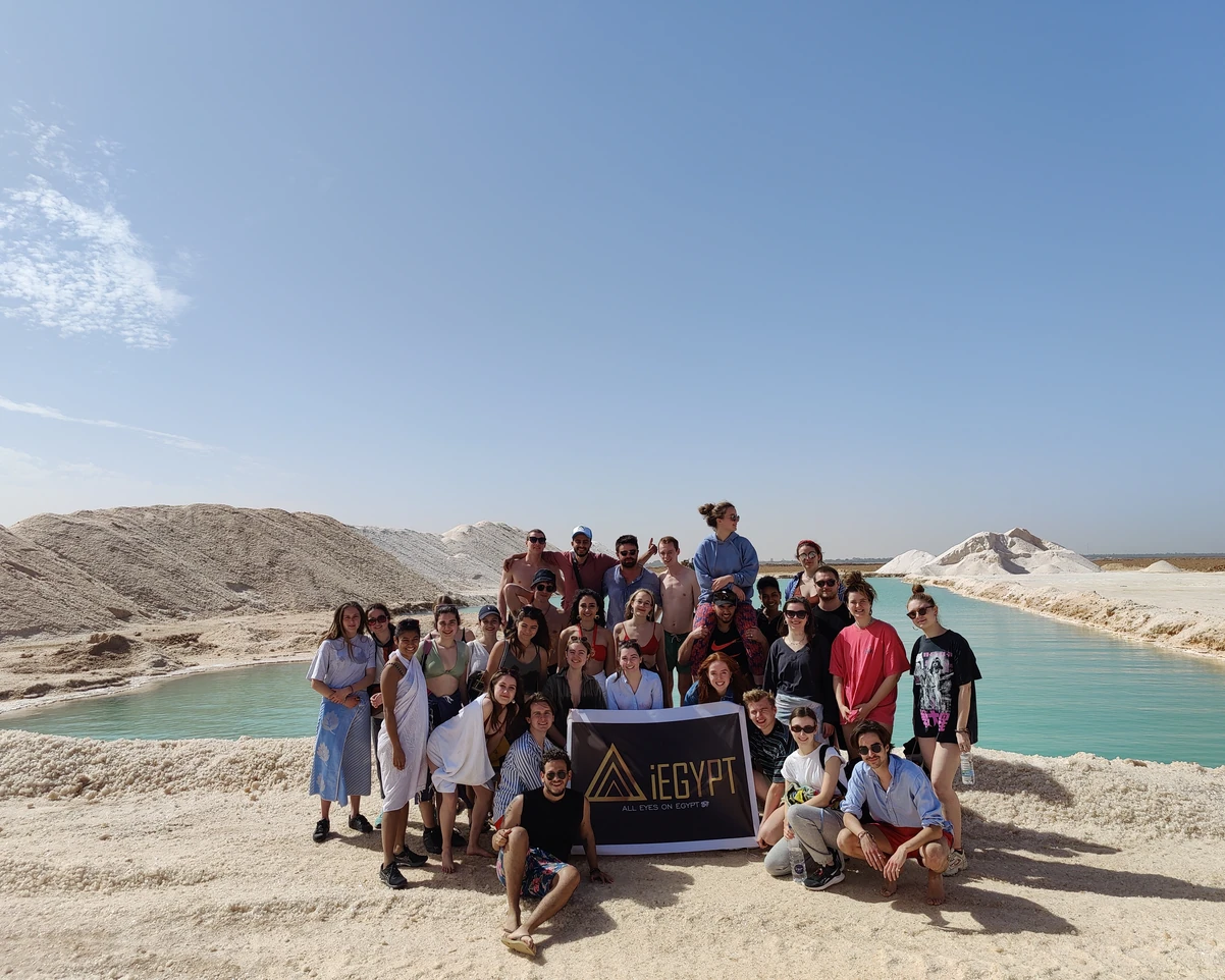 A group is taking photos in Siwa with stunning natural landscapes in the background