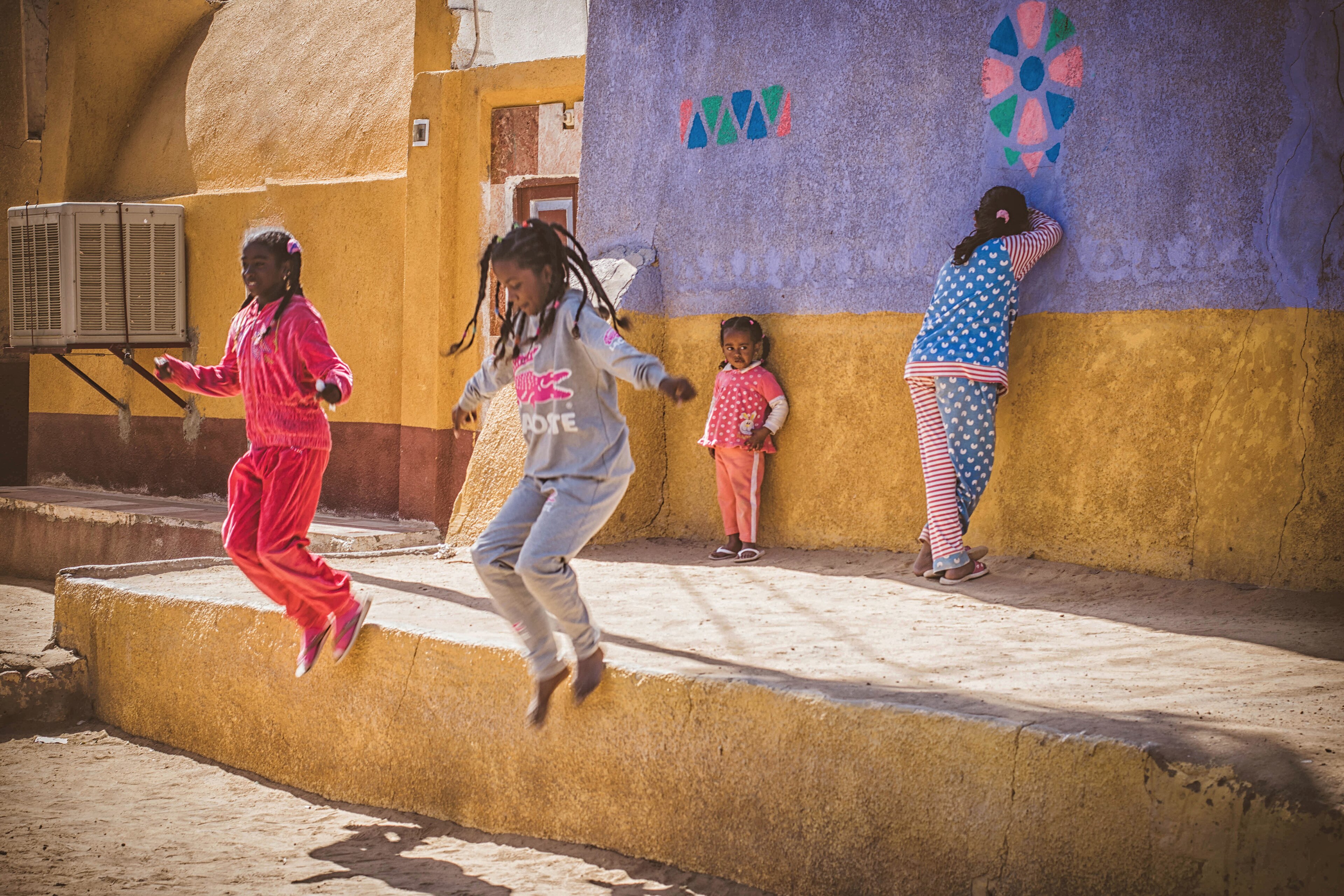 Children playing in a colourful Nubian village street in Aswan