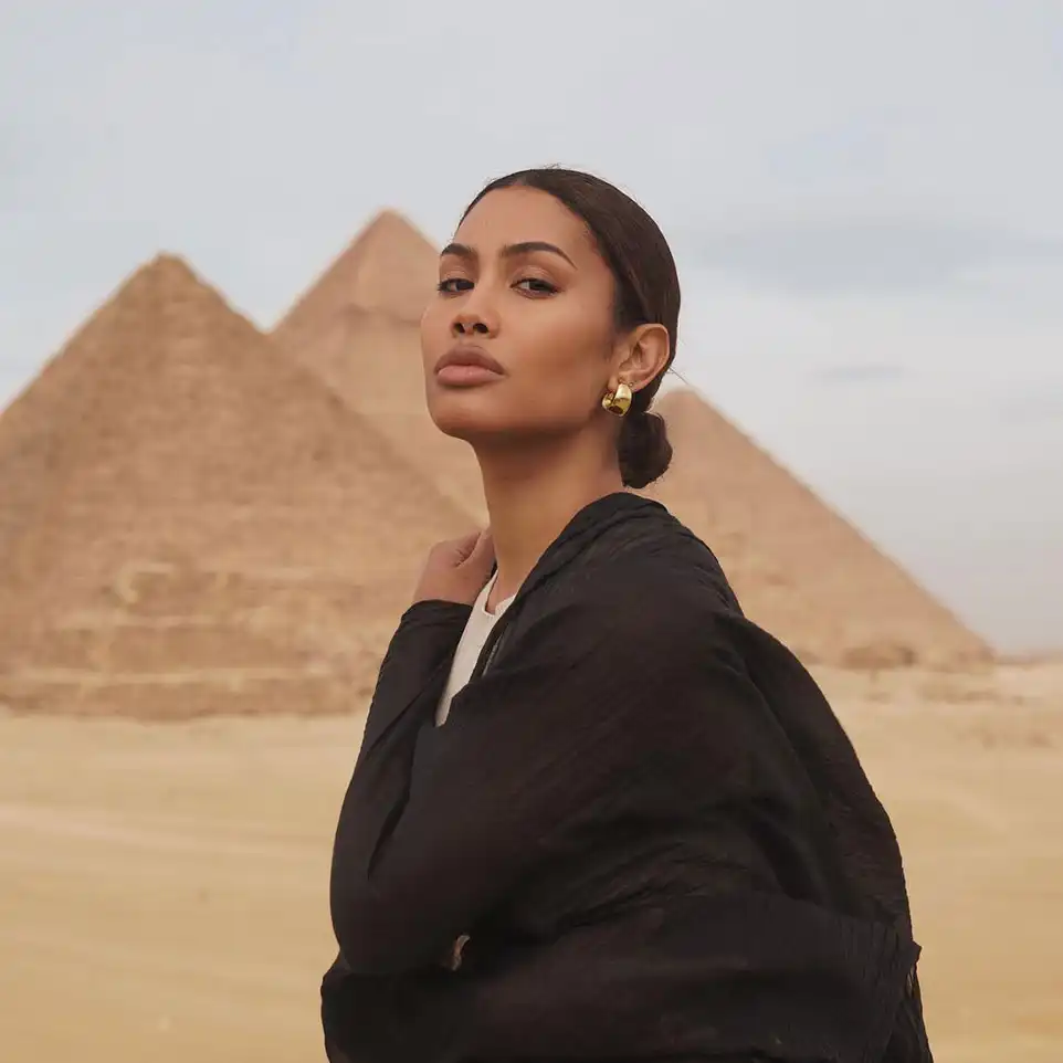 Leyna Bloom beautiful traveler wearing dress in the pyramids in the tour with iEgypt travels