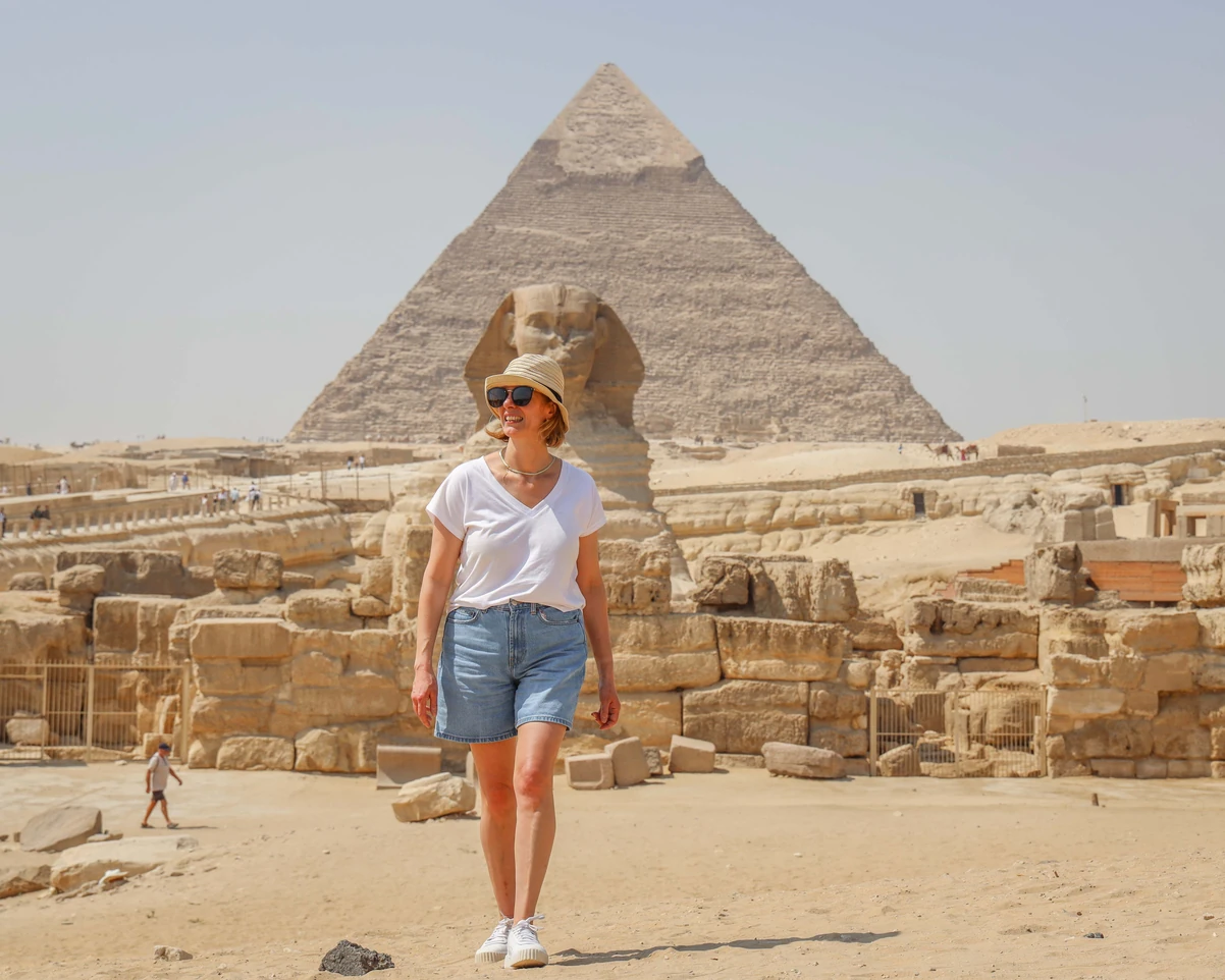 Leyna Bloom beautiful traveler wearing dress in the pyramids in the tour with iEgypt travels